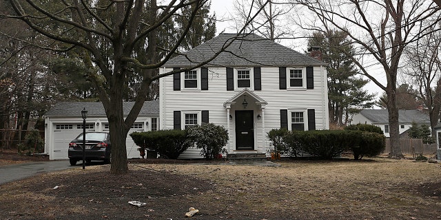 In this archival photo of March 20, 2019, a house that once belonged to Peter Brand is sitting on a tree in Needham, Massachusetts. Harvard University has fired its longtime fencing coach for the sale of his Boston suburban home to a wealthy son. His son was then admitted to school and joined the school. ;team. (Suzanne Kreiter / The Boston Globe via AP, File)