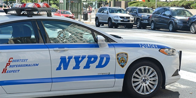 \A hybrid NYPD patrol car on street, evidencing an increase in use of vehicles that make use of alternative fuels with the aim to help curb pollution in Manhattan.