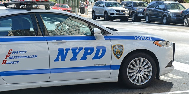 \A hybrid NYPD patrol car on street, evidencing an increase in use of vehicles that make use of alternative fuels with the aim to help curb pollution in Manhattan.