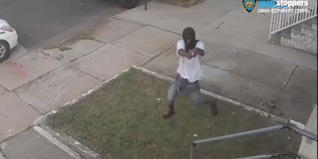 Screen image from video showing a gunman attempting to shoot a female victim in New York City Friday.