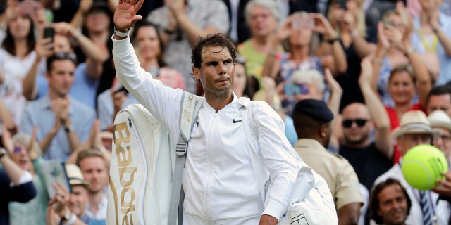 Rafael Nadal leaves the court after Friday's match. (AP Photo/Ben Curtis)