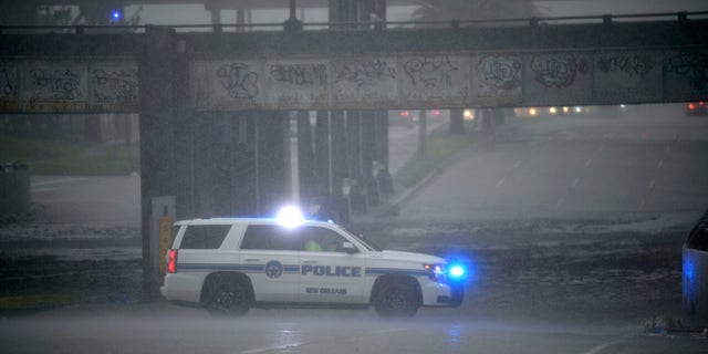 An NOPD cruiser blocks the underpass at S. Carrollton Ave. in New Orleans as severe thunderstorms caused street flooding, Wednesday, July 10, 2019.