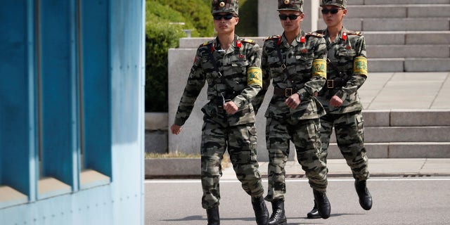 North Korean soldiers patrol at the truce village of Panmunjom inside the demilitarized zone separating the two Koreas, in May.