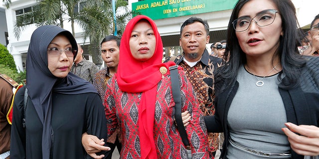 Nuril Maknun, center, arrives at the Attorney General's office in Jakarta, Indonesia, on July 12. (AP)