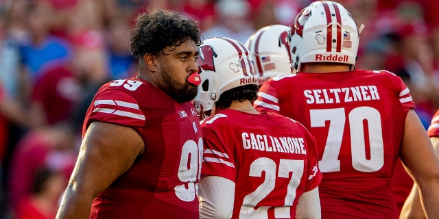 Wisconsin Badgers nose tackle Olive Sagapolu (99) consoles Wisconsin Badgers kicker Rafael Gaglianone (27) after missing the game-tying field goal. (Photo by Dan Sanger/Icon Sportswire via Getty Images)