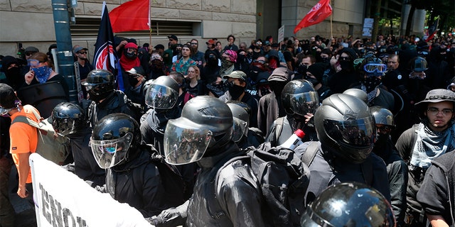 Multiple groups, including Rose City Antifa, the Proud Boys and conservative activist Haley Adams protest in downtown Portland, Ore., Saturday, June 29, 2019. (Dave Killen/The Oregonian via AP)