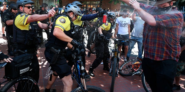 After a confrontation between authorities and protestors, police use pepper spray as multiple groups, including Rose City Antifa, the Proud Boys and others protest in downtown Portland, Ore., on Saturday, June 29, 2019.