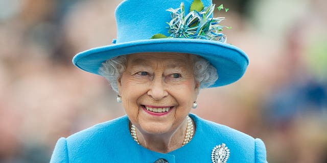 Queen Elizabeth II tours Queen Mother Square on October 27, 2016, in Poundbury, Dorset. (Photo by Samir Hussein/WireImage)