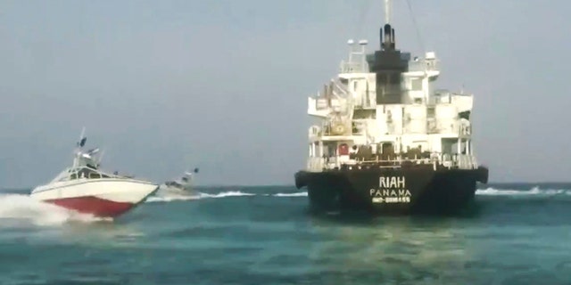 This undated photo provided by Iranian state television's English-language service, Press TV, shows the Panamanian-flagged oil tanker MT Riah surrounded by Iranian Revolutionary Guard vessels. (Press TV via AP)