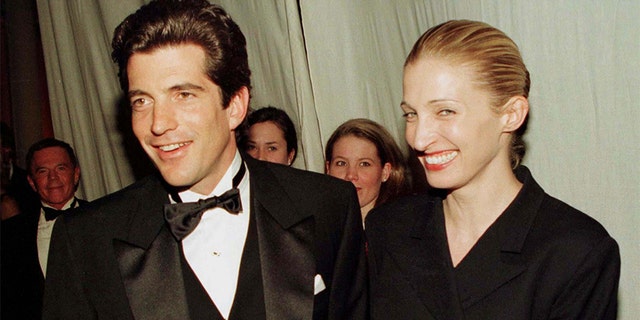 John F. Kennedy Jr. and his wife Carolyn Bessette stop for photographers after Kennedy presented actor Robert De Niro with the Municipal Art Society of New York's Jacqueline Kennedy Onassis Medal at a gala dinner in New York, March 4. De Niro was honored for his outstanding contribution to the preservation of New York City's neighborhoods.