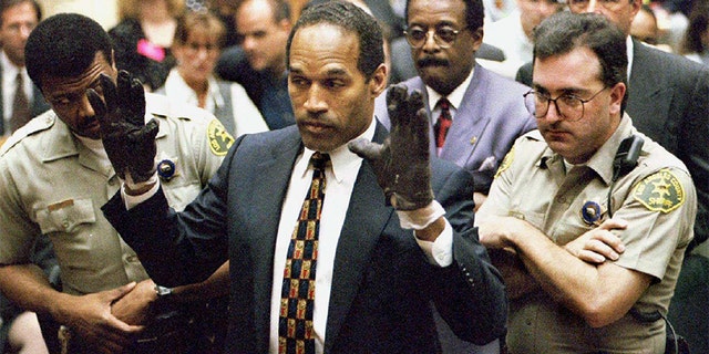 O.J. Simpson holds up his hands to the jury in this June 15, 1995 file photo.