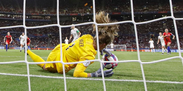 United States goalkeeper Alyssa Naeher saves a penalty shot taken by England's Steph Houghton during the Women's World Cup semifinal soccer match between England and the United States, at the Stade de Lyon, outside Lyon, France, Tuesday, July 2, 2019. (AP Photo/Alessandra Tarantino)