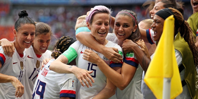 United States' Megan Rapinoe, center, celebrates after scoring the opening goal from the penalty spot during the Women's World Cup final soccer match between US and The Netherlands at the Stade de Lyon in Decines, outside Lyon, France, Sunday, July 7, 2019. (AP Photo/Francisco Seco)
