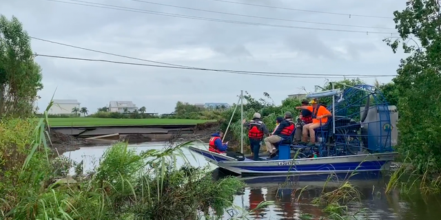 Louisiana's Governor John Bel Edwards tours a collapsed levee and sunken road in Myrtle Grove, La. after Barry's heavy rain caused water to overtop the levee.