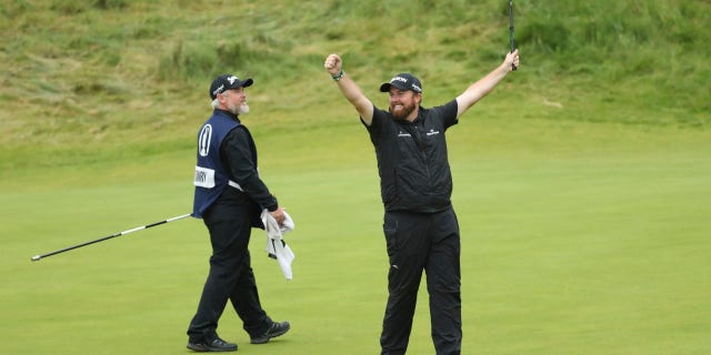 Ireland's Shane Lowry lifts his club to celebrate as he wins the British Open Golf Championships at Royal Portrush in Northern Ireland, Sunday, July 21, 2019.