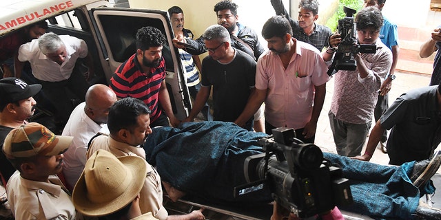 The body of missing Indian coffee tycoon V.G. Siddhartha is wheeled on a stretcher from an ambulance to a cold storage unit after local fishermen found it floating in the Netravati river in the coastal city of Mangalore in the southern state of Karnataka on July 31, 2019. (STR/AFP/Getty Images)