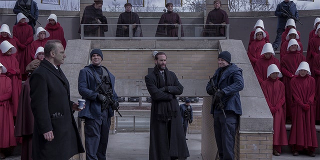 The Handmaid's Tale -- "Bear Witness" - Episode 310 -- Ready to strike back at her oppressors, June starts making arrangements for an ambitious plan, but a devious ploy on the part of Commander Waterford threatens to derail her. In Canada, hope turns to tragedy for Moira, Luke, and Emily. Winslow (Christopher Meloni) and Fred (Joseph Fiennes), shown. (Photo by Sophie Giraud/Hulu)