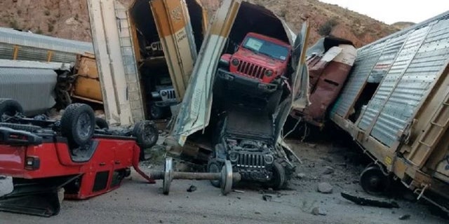 Dozens of cars and vans were damaged Wednesday when the train in which they were transported derailed in Nevada. 