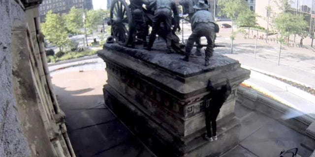 A suspect is seen climbing the Soldiers' and Sailors' Monument in Cleveland on Wednesday evening. (Surveillance video)