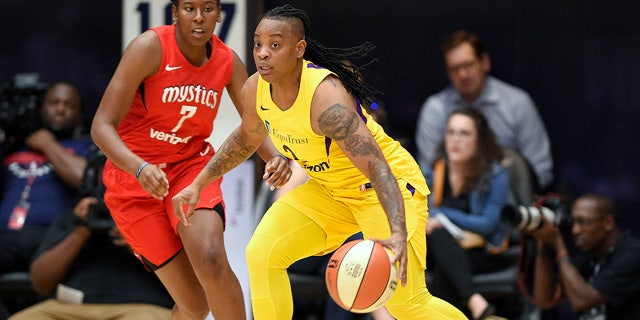 Riquna Williams, right, faces burglary and aggravated assault charges in connection with the Dec. 6 incident. (AP Photo/Nick Wass, File)