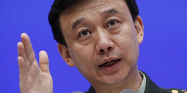 China's Defense Ministry spokesman Wu Qian gestures as he speaks during a press conference at the State Council Information Office in Beijing, Wednesday, July 24, 2019. China says it will not "renounce the use of force" in efforts to reunify Taiwan with the mainland and vows to take all necessary military measures to defeat "separatists." (AP Photo/Andy Wong)