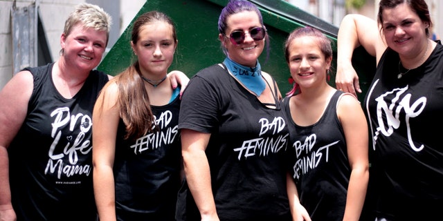 Destiny Herndon-De La Rosa, New Wave Feminists, and Abby Johnson taking a break from unloading supplies at respite center in McAllen, Texas.