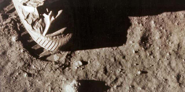 Astronaut Neil Armstrong's right foot leaves a footprint in lunar soil