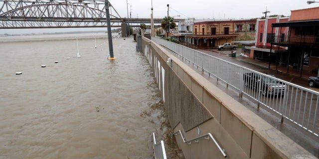 As the Atchafalaya River continues to rise due to the rains of Tropical Storm Barry, it becomes harder to see the Morgan City name on the sea wall, Saturday, July 13, 2019, in Morgan City, La.
