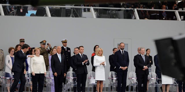 From the left, Dutch Prime Minister Mark Rutte, German Chancellor Angela Merkel, Portugal's President Marcelo Rebelo de Sousa, French President Emmanuel Macron, his wife Brigitte, French Prime Minister Edouard Philippe and Finnish President Sauli Niinisto attend Bastille Day parade Sunday, July 14, 2019, on the Champs Elysees avenue in Paris