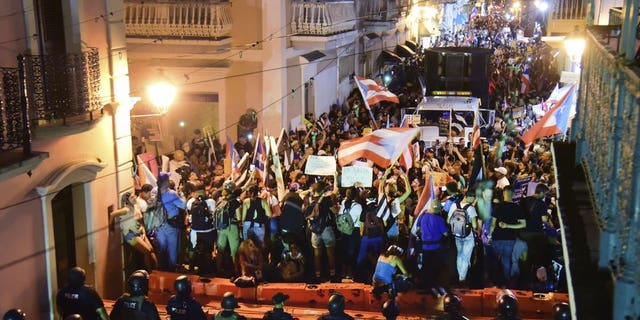 Demonstrators protest against governor Ricardo Rossello, in San Juan, Puerto Rico, Friday, July 19, 2019. Protesters are demanding Rossello step down for his involvement in a private chat in which he used profanities to describe an ex-New York City councilwoman and a federal control board overseeing the island's finance.