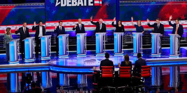 Candidates were asked to raise their hands if they would provide healthcare for undocumented immigrants during the Democratic primary debate hosted by NBC News last month. (AP Photo/Wilfredo Lee)