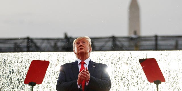President Donald Trump looks up during the military flyovers at the Independence Day celebration in front of the Lincoln Memorial, Thursday, July 4, 2019, in Washington. The Washington Monument is in the background. (AP Photo/Carolyn Kaster)