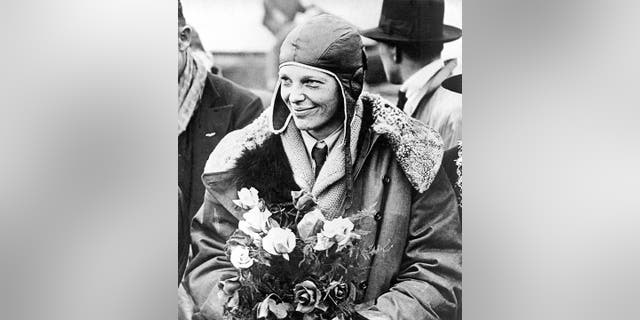 FILE - In this June 26, 1928, file photo, American aviatrix Amelia Earhart poses with flowers as she arrives in Southampton, England, (AP Photo, File)