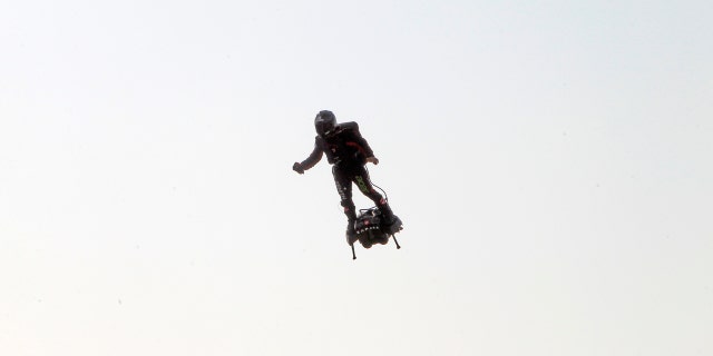 Zapata was anchored to his flyboard, a small flying platform he invented, taking off from Sangatte, in France's Pas de Calais region, and flying to the Dover area in southeast England. (AP Photo/Michel Spingler)