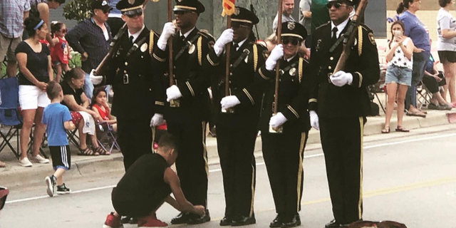 The boy – identified by police as "Josh" – ran out at the start of the parade after he noticed one of the Honor Guard members holding the American flag had his shoe untied.<br>