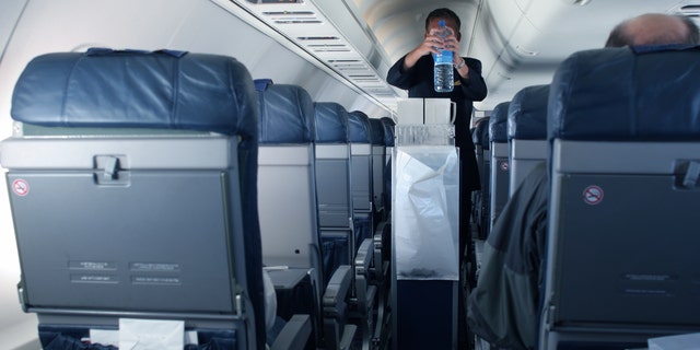 Flight attendant Kat Kamalani posted a video on TikTok explaining the grossest places on an airplane including the tray tables and seatbelt buckles. (iStock)