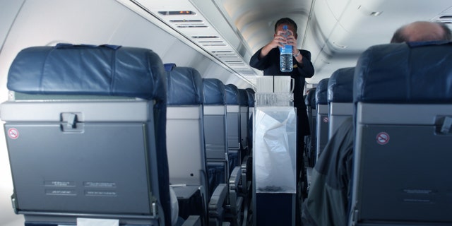 Flight attendant Kat Kamalani posted a video on TikTok explaining the grossest places on an airplane including the tray tables and seatbelt buckles. (iStock)