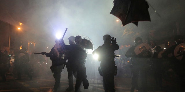 Hong Kong police launched tear gas at protesters Sunday after a massive pro-democracy march continued late into the evening.