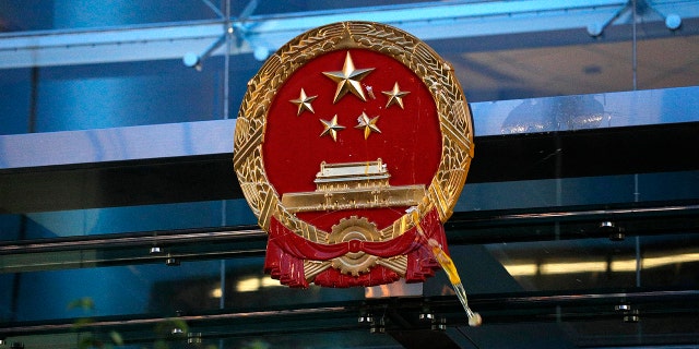 An egg thrown by a protester hits the National Emblem of the People's Republic of China at the Chinese Liaison Office in Hong Kong on Sunday, July 21, 2019. Protesters in Hong Kong pressed on Sunday past the designated end point for a march in which tens of thousands repeated demands for direct elections in the Chinese territory and an independent investigation into police tactics used in previous demonstrations. (AP Photo/Bobby Yip)