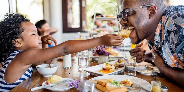 A family enjoys breakfast together. Consider a fresh and delicious crêpe recipe as a fun new offering for family or friends.