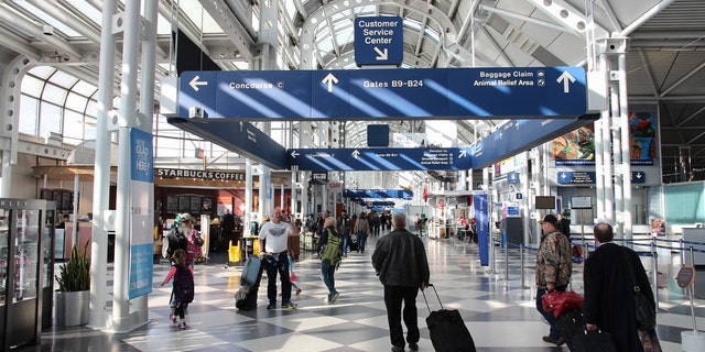 Chicago, United States - April 1, 2014: Travelers walk to gates at Chicago O'Hare International Airport in USA. It was the 5th busiest airport in the world with 66,883,271 passengers in 2013.