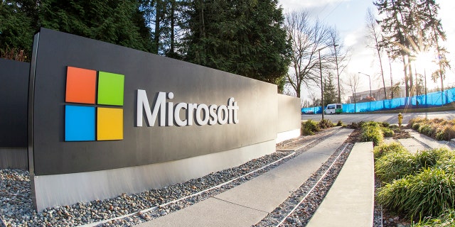 Redmond, WA, USA - January 30, 2018: One of the biggest Microsoft signs is placed next to green trees at a public intersection near Microsoft's Redmond campus