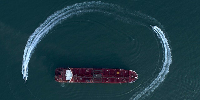 An aerial view shows a speedboat of Iran's Revolutionary Guard moving around the British-flagged oil tanker Stena Impero which was seized in the Strait of Hormuz on Friday. (AP/Tasnim News Agency)