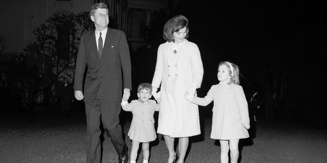 White house Jackie and John Kennedy walk with their two children, John and Caroline. (Getty)