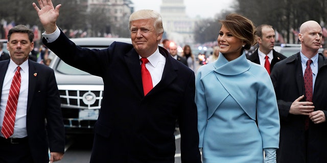 U.S. President Donald Trump and first lady Melania Trump walk during the inaugural parade from the U.S. Capitol in Washington, U.S., January 20, 2017.