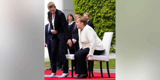 German Chancellor Angela Merkel, right, and Danish Prime Minister Mette Frederiksen, left, take their seats during the welcoming ceremony for a meeting at the chancellery in Berlin, Thursday, July 11.