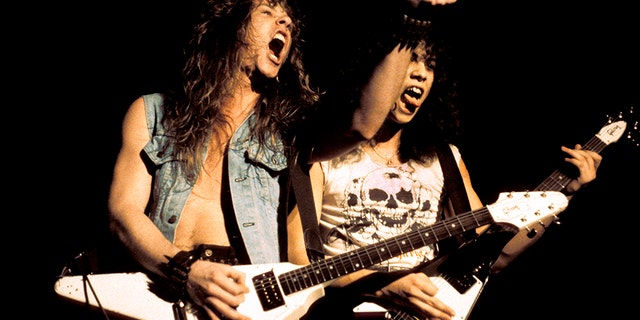 James Hetfield and Kirk Hammett performing live onstage, playing Gibson Flying V guitars (Photo by Pete Cronin/Redferns)