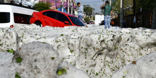 Vehicles lie entombed in ice after a freak hailstorm struck Guadalajara, Mexico on Sunday.