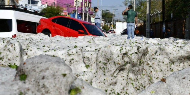Vehicles lie entombed in ice after a freak hailstorm struck Guadalajara, Mexico on Sunday.