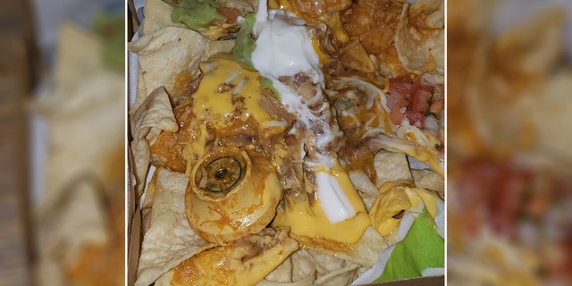 Saint, who originally thought the foreign object was a “doorknob,” found out later it was actually a “nacho cheese handle,” that had somehow made it into her food.